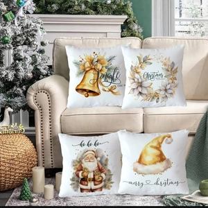 Detail of four Christmas pillow covers with gold illustrations on a cozy beige sofa
