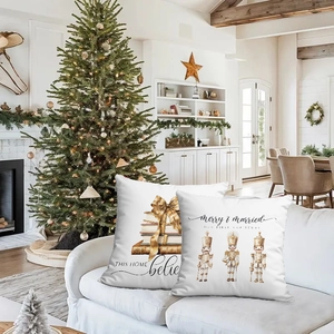 Detail of white Christmas pillow covers featuring Nutcracker and festive book prints