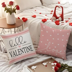 Detail showing two Valentine's day pillows with heart patterns and love prints on linen
