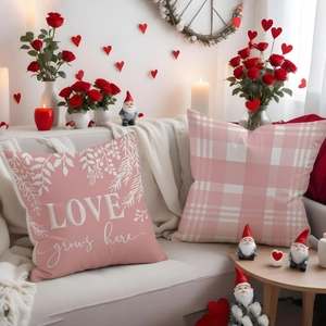Detail of linen pillowcases with LOVE grows here print and pink checkered pattern