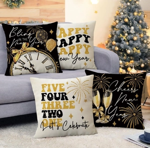 Detail of four Happy New Year linen pillow covers with champagne and clock patterns