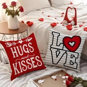 Close-up of Valentine's Day pillow covers with Love and Hugs and Kisses prints on a bed