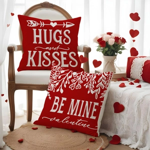 Detail of red Valentine's pillow covers featuring Hugs and Kisses text and vine patterns