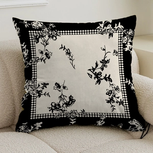 Detailed view of cream fabric pillowcase with artistic black floral and checkerboard patterns