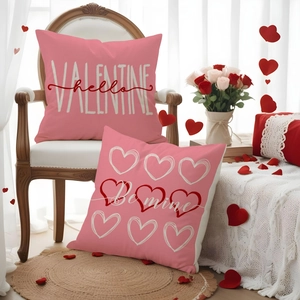 Detail of pink Valentine's Day pillow covers with heart patterns and romantic lettering