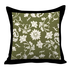 Detail of olive green pillow cover with white floral patterns and black border trim