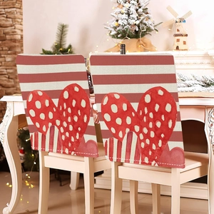 Detail of red and white striped chair covers with heart pattern for festive dining decor
