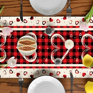 Valentine's Day table runner with red buffalo plaid heart pattern on rustic wood table