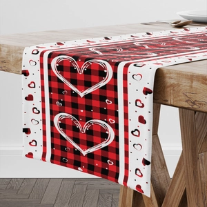 Red buffalo plaid table runner with heart prints for Valentine's Day dining decor