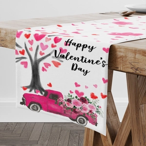 Valentine's Day table runner featuring heart tree and pink flower truck on wood table