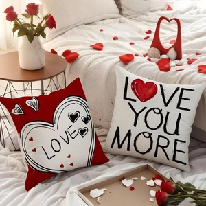 Detail of Valentine linen pillow covers featuring Love You More text and heart designs