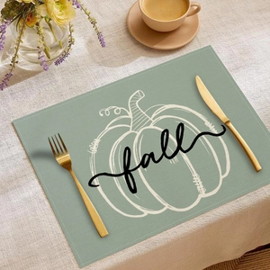 Sage green linen placemat featuring white pumpkin line art and fall typography decoration