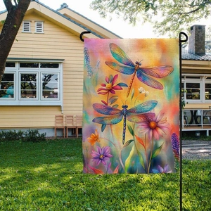 Close-up of a rustic burlap garden flag featuring vibrant dragonflies and spring flowers