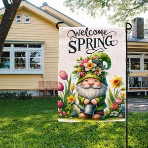 Detail of burlap Easter garden flag showing a cute gnome and flowers in a garden setting