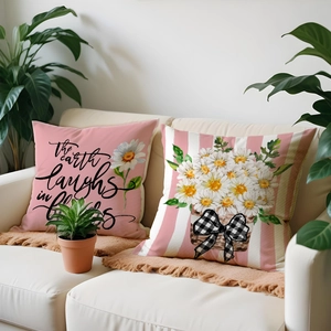 Cozy home decor set with pink floral daisy pillows on sofa with spring flower phrases