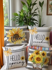 Set of four linen sunflower pillow covers with artistic letter prints on a white sofa