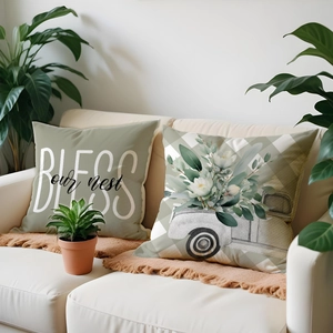 Close-up of decorative pillow covers with floral truck pattern and BLESS our nest text