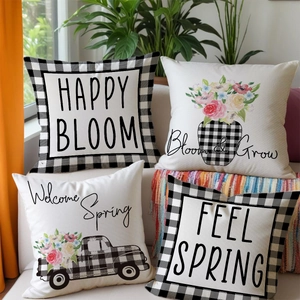Set of four farmhouse spring pillow covers with floral and buffalo plaid prints on a sofa