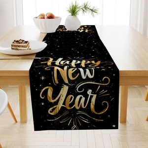 Detail of Happy New Year table runner with gold lettering on a black festive fabric