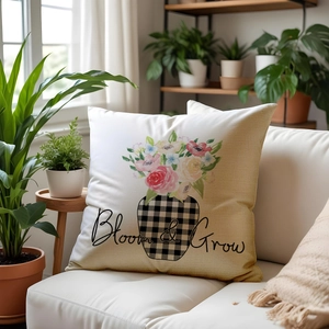 Linen decorative pillow cover with Bloom & Grow floral print on a white sofa