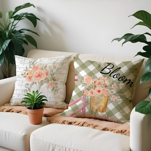 Detail of floral spring pillow covers with Spring and Bloom text on a cozy sofa