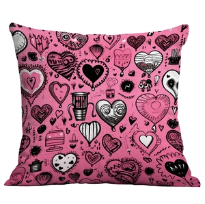 Macro view of pink throw pillow featuring black and white punk style heart graffiti prints