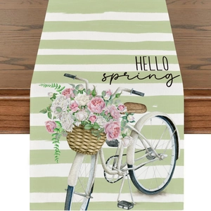 Detailed view of Hello Spring table runner with bicycle and flower print on wood table