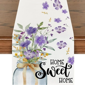 Detail of floral table runner with Home Sweet Home print on rustic wooden table