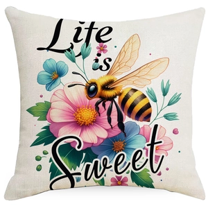 Close-up of linen pillowcase with Life is Sweet quote and colorful bee flower print