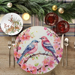 Detailed macro view of round placemat featuring floral bird print and textured linen fabric