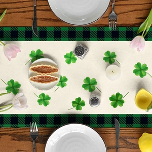 Detail of St. Patrick's Day table runner with green clover print on buffalo plaid edges