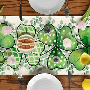Detail of St. Patrick's Day table runner with green clover print on linen fabric