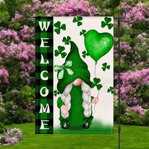 Macro detail of St. Patrick's Day garden flag with gnome and welcome text on burlap fabric