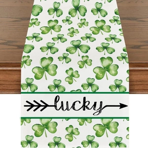 Detail of St. Patrick's Day table runner with green clovers and Lucky text on wood