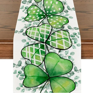 Saint Patrick's Day table runner with green shamrock patterns on wooden dining table