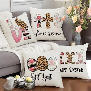 Detailed view of four Easter bunny pillow covers with leopard print on a grey sofa
