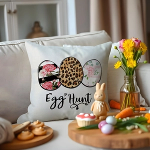 Easter egg hunt pillow case with floral patterns and bunny decor on white sofa