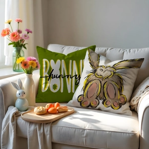 Detail of Easter pillow covers featuring bunny motifs and text on rustic linen fabric