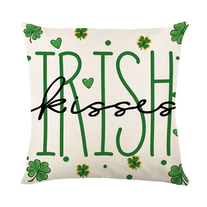 St. Patrick's Day cushion cover with green shamrock print and Irish Kisses text design