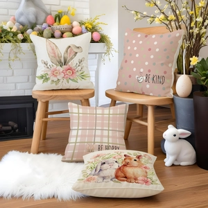 Close-up of Easter linen pillowcases featuring floral rabbits and be happy text print