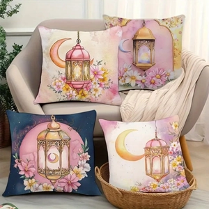 Detailed view of four watercolor moon and lantern pattern cushion covers on a sofa