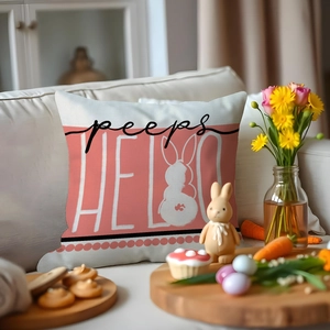Pink Easter bunny throw pillow with 'HELLO peeps' text on a white sofa scene