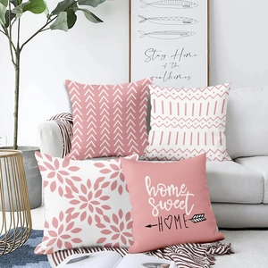 Detail of four pink and white plush pillow covers with floral and home sweet home prints