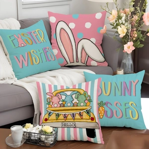 Set of four Easter linen pillow covers with bunny and floral prints on a gray sofa