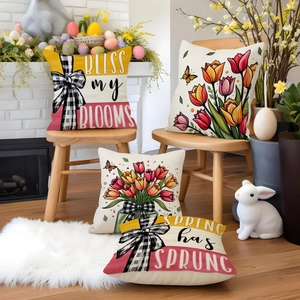 Detailed view of four spring tulip and floral pillow covers with festive home decor