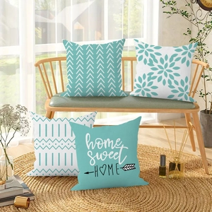 Detail view of four modern nordic plush pillow covers with geometric patterns and text