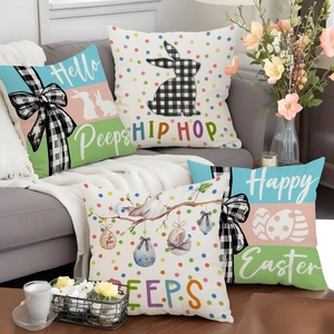 Set of 4 Easter decorative pillow covers with rabbit and egg patterns on a gray sofa