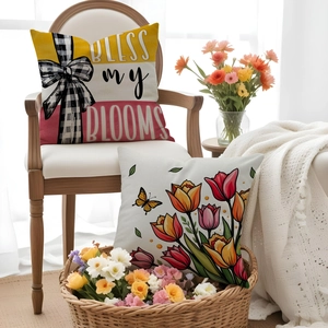 Close-up of decorative tulip flower pillowcases with Bless My Blooms text on a wooden chair