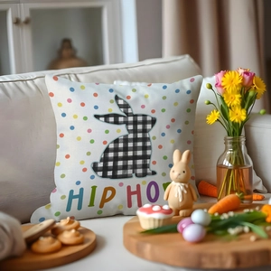 Close-up of Easter cushion cover with plaid bunny and colorful dots on a cozy white sofa