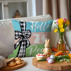 Detailed view of Hello Peeps Easter cushion with bunny pattern and bow on a white sofa